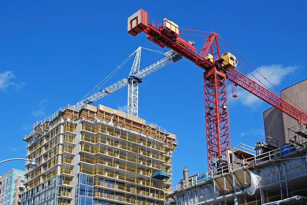 Construction site with tower cranes and a building under construction